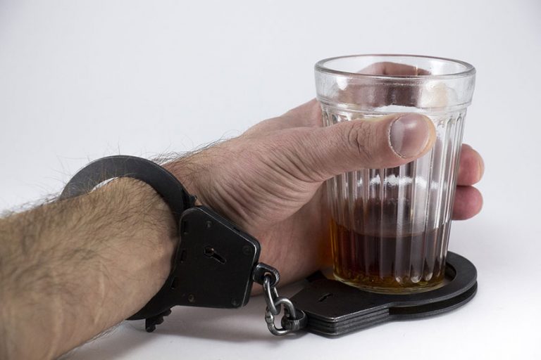 man-handcuffs-holding-alcohol