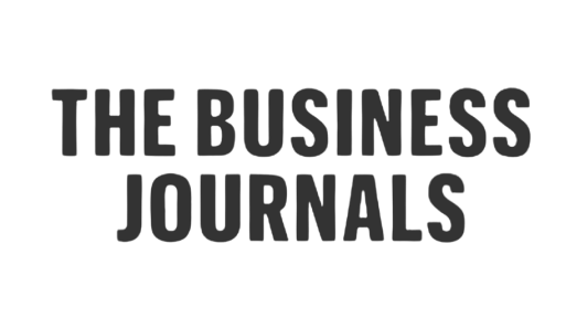 Logo of The Business Journals with black uppercase text on a white background.