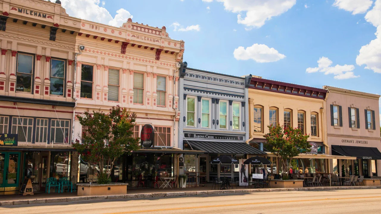 A row of historic Georgetown buildings with shops and restaurants on the ground floor sits under a partly cloudy sky, offering charm and legal services from a nearby DWI lawyer.